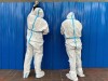 Workers in protective suits set up barriers outside a building, following the coronavirus disease (COVID-19) outbreak, in Shanghai