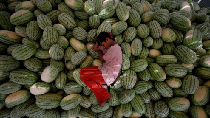 Faire Woche: Ein klares Bekenntnis gegen Kinderarbeit - hier ein Junge, der erschöpft auf einem Wassermelonenlager in Mumbai eingeschlafen ist - wollen viele Kommunen in der bundesweiten Aktion "Faire Woche" abgeben.