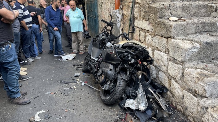 Gewalt im Westjordanland: Palästinenser in Nablus umringen das zerstörte Motorrad, an dem eine Bombe zur Tötung von Tamer al-Kilani befestigt gewesen sein soll.