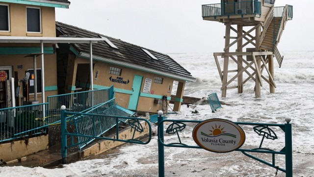Unwetter: Wellen schlagen in der Nähe eines beschädigten Gebäudes und eines Rettungsschwimmerturms in Daytona Beach auf
