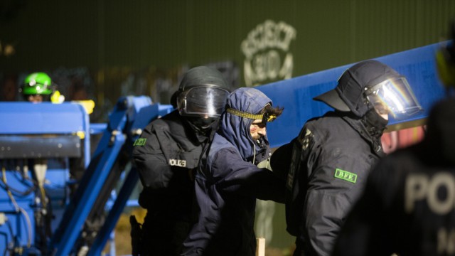 Eviction of Lützerath: Police officers take away a climate activist.  The energy company RWE wants to excavate the coal lying under Lützerath - the hamlet is to be demolished for this.