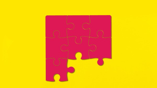 Puzzle pieces on yellow background.