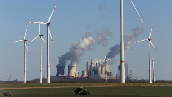 Stromkonzern: Klimaretter und Klimakiller: Windräder von RWE stehen vor dem Braunkohlekraftwerk Neurath, das der Konzern in Nordrhein-Westfalen betreibt.