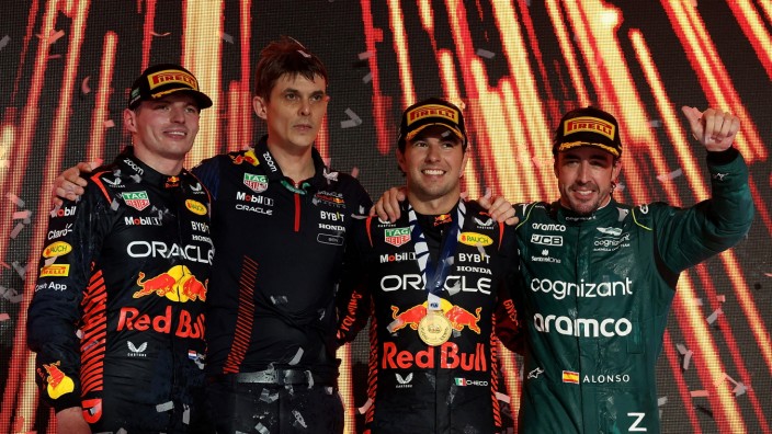 Formel 1: Die Schnellsten, aber mit Abstand: Sergio Perez (2. v.re.) gewinnt den Großen Preis von Dschidda vor seinem Teamkollegen Max Verstappen (links). Zwischen den beiden steht Red-Bull-Renningenieur Ben Waterhouse und ganz rechts der lachende Drittatzierte Fernando Alonso.