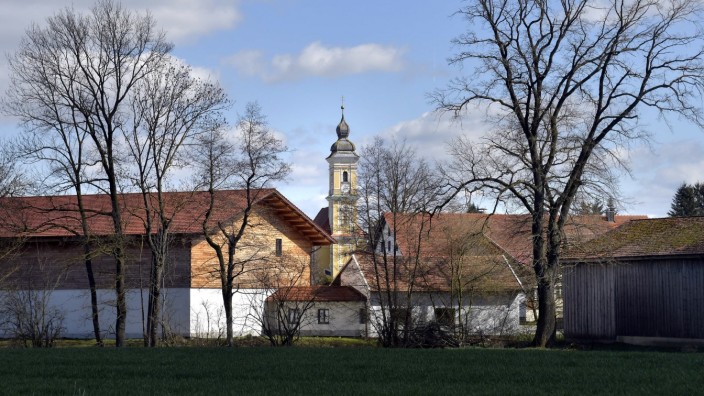 Stadtentwicklung in Erding: Zwischen landwirtschaftlichen Gebäuden spitzt St. Vitus hervor: Itzling ist Teil der Großen Kreisstadt Erding, die Ortschaft hat sich aber ihren dörflichen Charakter bewahrt.