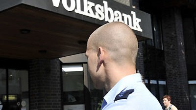 Krefeld: Polizist vor der überfallenen Bankfiliale in Krefeld: Zwei Täter sind auf der Flucht.