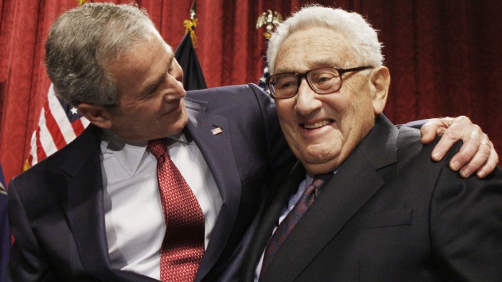 Reaktionen auf Kissingers Tod: Der damalige US-Präsident George W. Bush (li.) umarmt den früheren US-Außenminister Henry Kissinger. (Archivbild von Anfang 2008)
