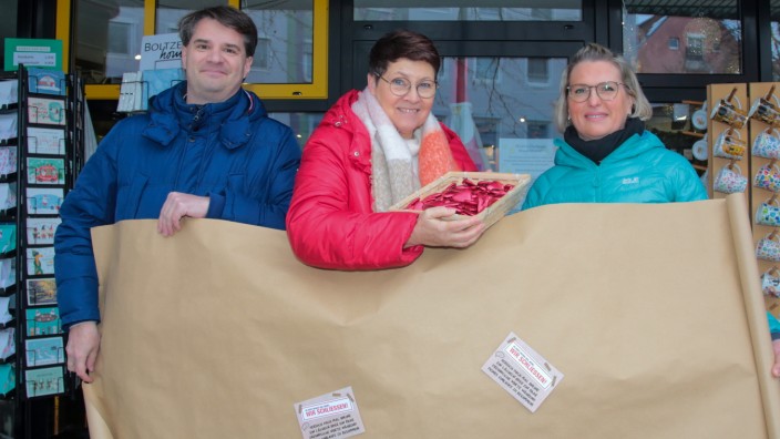 "Wir schließen": Von links: Alexander Broschell (Leiter Abteilung Wirtschaftsförderung), Isabel Seeber (Vorsitzende Dachau handelt) und Kristin Sattler (Mitarbeiterin Wirtschaftsförderung) mit dem braunen Packpapier, mit dem viele Geschäfte in Dachau verhüllt werden.