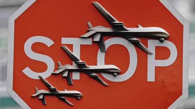 London: The British street artist's latest work: a stop sign with three drones attached.