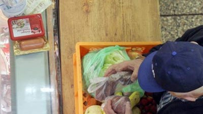 "Tafeln" für Arme: Älterer "Tafelkunde" versorgt sich mit Obst