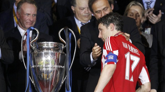 Bayern Munich's captain Mark van Bommel receives his losers medal from UEFA President Michel Platini after their Champions League final soccer match against Inter Milan at the Santiago Bernabeu stadium in Madrid