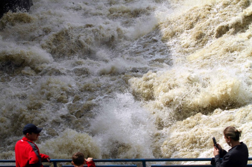People look at the high waters of the Wisla river from the water dam, after flash floods in Wloclawek