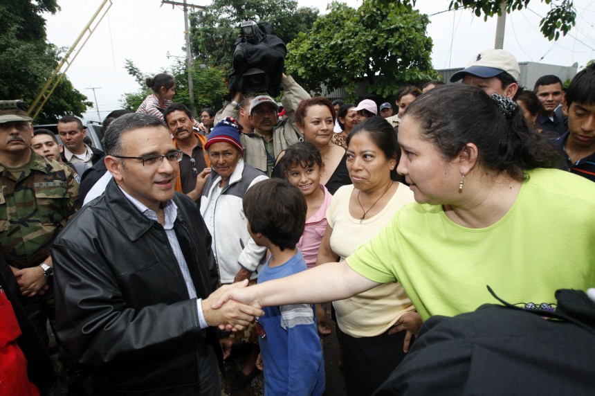 The President of El Salvador Mauricio Funes speaks to residents during a tour of the destruction brought on by Tropical Storm Agatha in San Salvador
