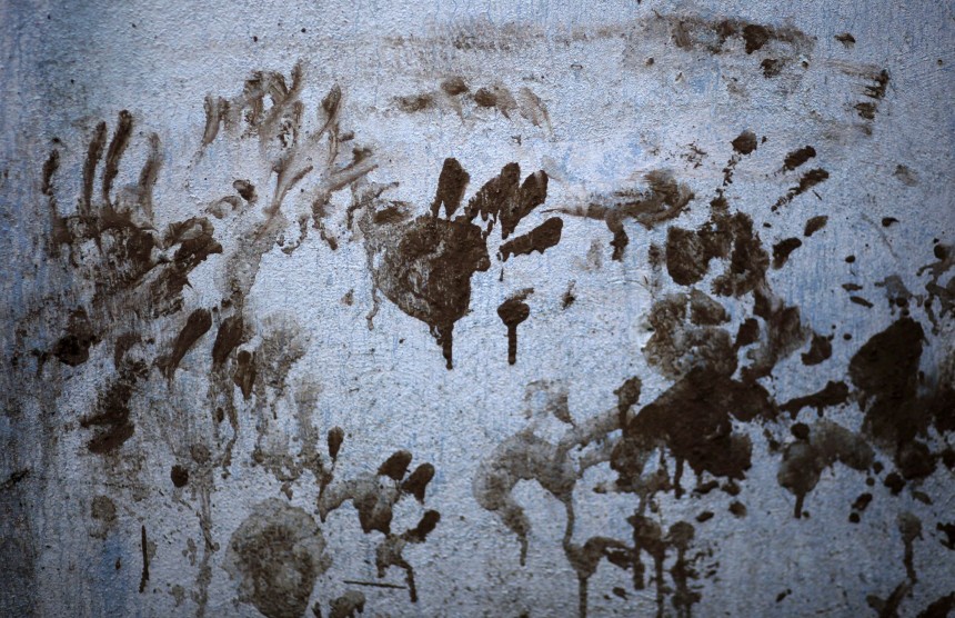 Muddy hand prints are pictured on the the wall of a house in the el Pedregal neighborhood of Amatitlan