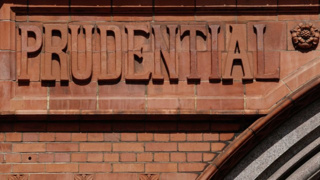 Raised lettering in the brickwork of the former Prudential Assurance building casts shadows in the City of London
