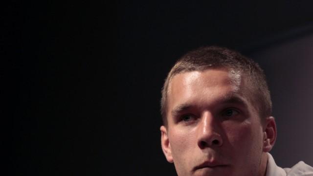 Germany's Podolski listens during a news conference at the Velmore hotel in Pretoria