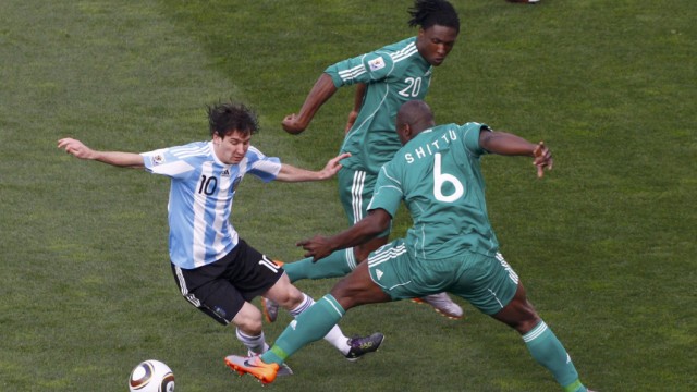 Argentina's Lionel Messi fights for the ball with Nigeria's Danny Shittu during a 2010 World Cup Group B soccer match at Ellis Park stadium
