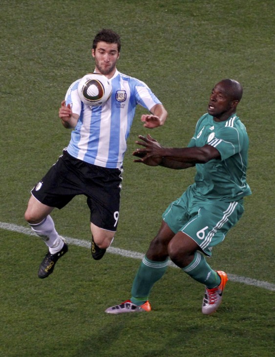 Argentina's Gonzalo Higuain fights for the ball with Nigeria's Danny Shittu during a 2010 World Cup Group B soccer match at Ellis Park stadium