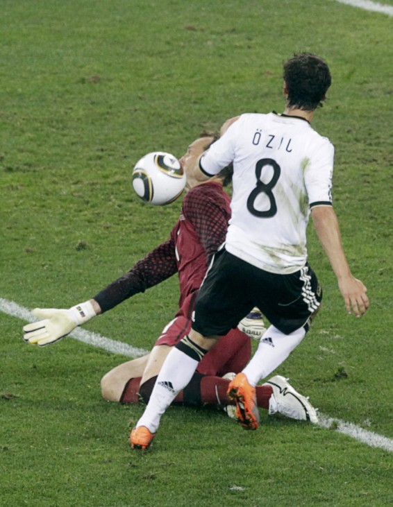Australia's goalkeeper Schwarzer deflects the ball from Germany's Ozil during the 2010 World Cup Group D soccer match in Durban