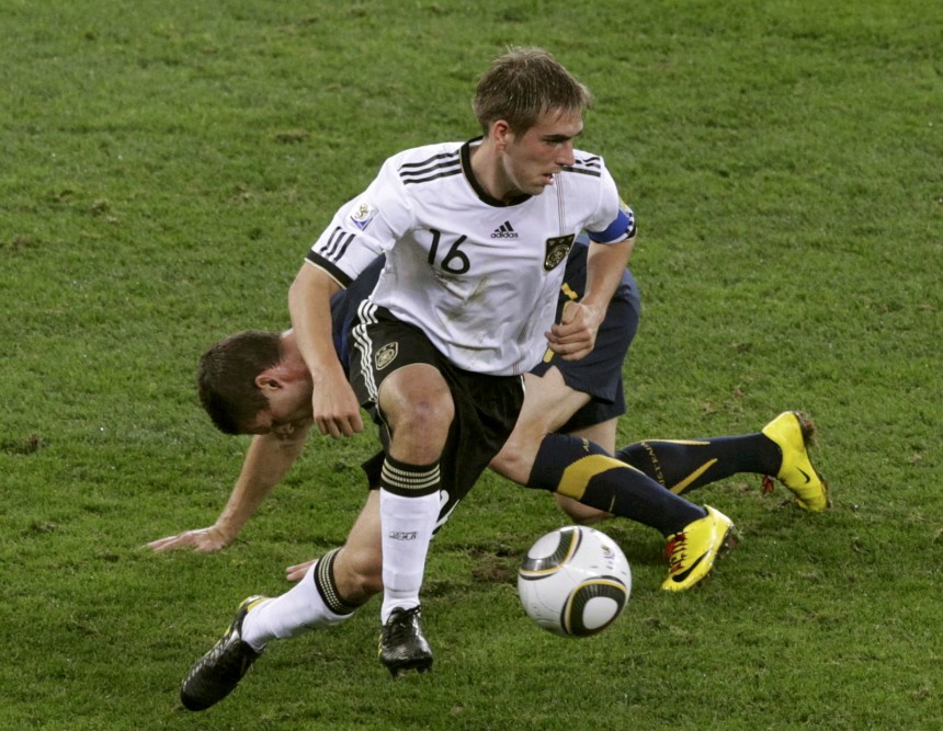 Germany's Lahm challenges Australia's Culina during their 2010 World Cup Group D soccer match at Moses Mabhida stadium in Durban