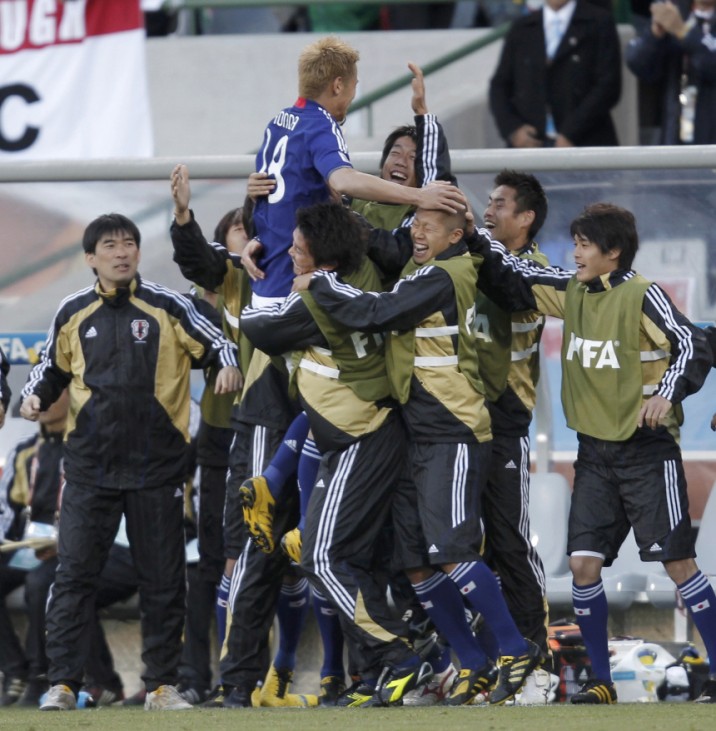 Japan's Keisuke Honda celebrates with team mates after scoring a goal against Cameroon during their 2010 World Cup Group E soccer match at Free State stadium in Bloemfontein