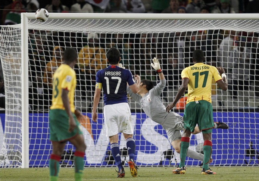 Japan's goalkeeper Kawashima tries to save a shot by Cameroon's Mbia as the ball hits the crossbar during the 2010 World Cup Group E soccer match