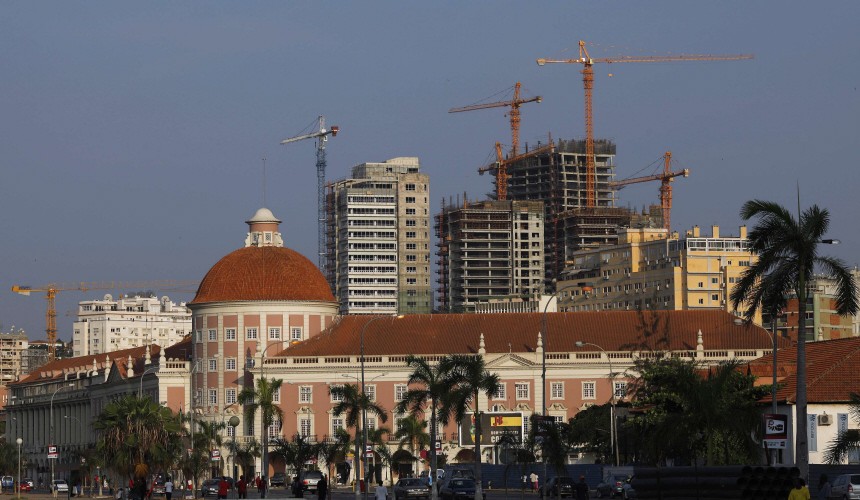 Office buildings under construction stand behind the Angolan central bank building in the capital, Luanda
