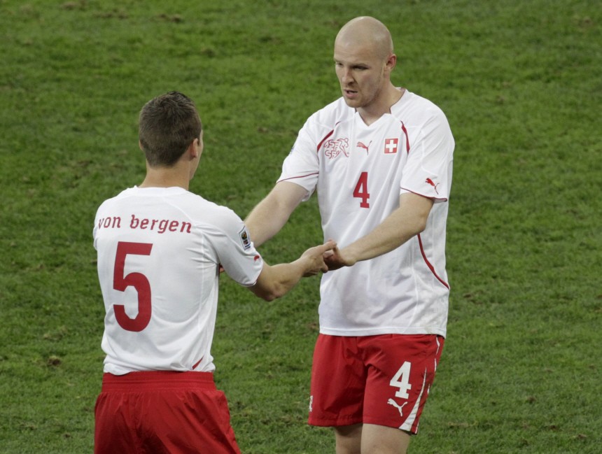 Switzerland's Philippe Senderos greets team mate Steve Von Bergen after the former was substituted during their 2010 World Cup Group H match against Spain at Moses Mabhida stadium in Durban
