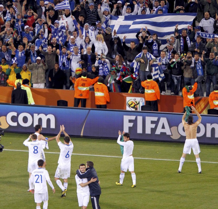 Greece players and their fans celebrate after their 2010 World Cup Group B soccer match at Free State stadium in Bloemfontein