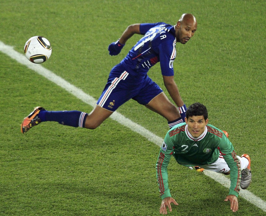 France's Anelka fights for the ball against Mexico's Rodriguez during the 2010 World Cup Group A soccer match at Peter Mokaba stadium in Polokwane