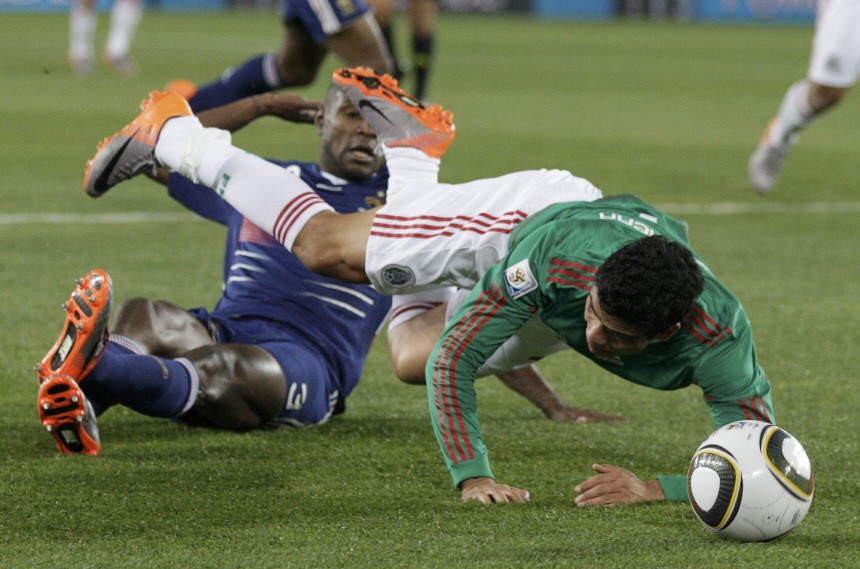 France's Eric Abidal tackles Mexico's Pablo Barrera during their 2010 World Cup Group A soccer match at Peter Mokaba stadium in Polokwane