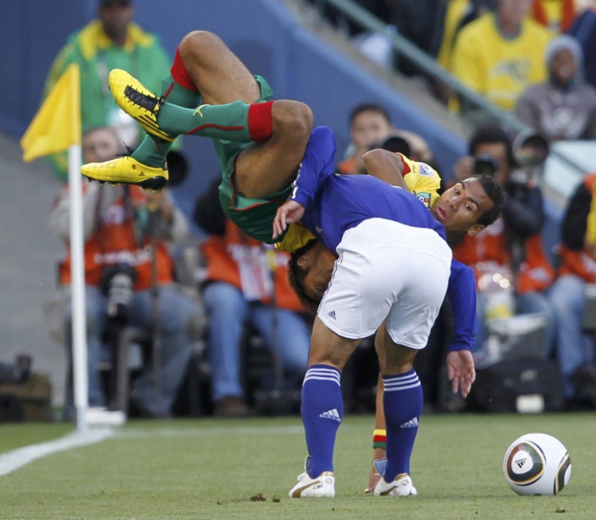 Japan's Yuichi Komano (bottom) is challenged by Cameroon's Eric Choupo-Moting during their 2010 World Cup Group E soccer match at Free State stadium in Bloemfontein