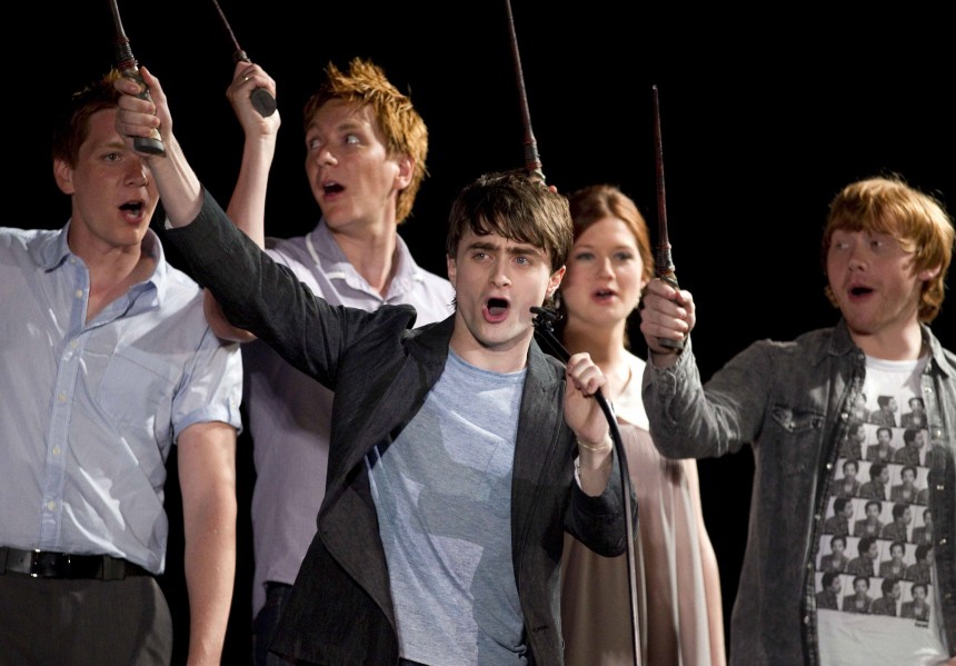 Daniel Radcliffe and members of the cast of Harry Potter wave their wands in Orlando, Florida