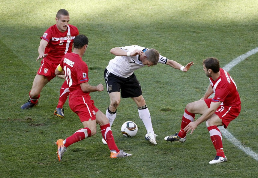 Germany's Schweinsteiger is surrounded by Serbian players during a 2010 World Cup Group D soccer match at Nelson Mandela Bay stadium in Port Elizabeth