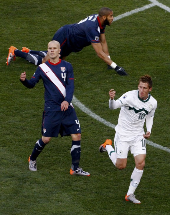 Slovenia's Birsa celebrates near Bradley of the US after scoring a goal during a 2010 World Cup Group C soccer match in Johannesburg