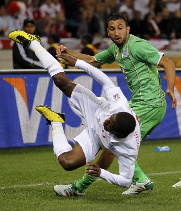 Algeria's Belhadj fights for the ball with England's Heskey during a 2010 World Cup Group C soccer match at Green Point stadium in Cape Town