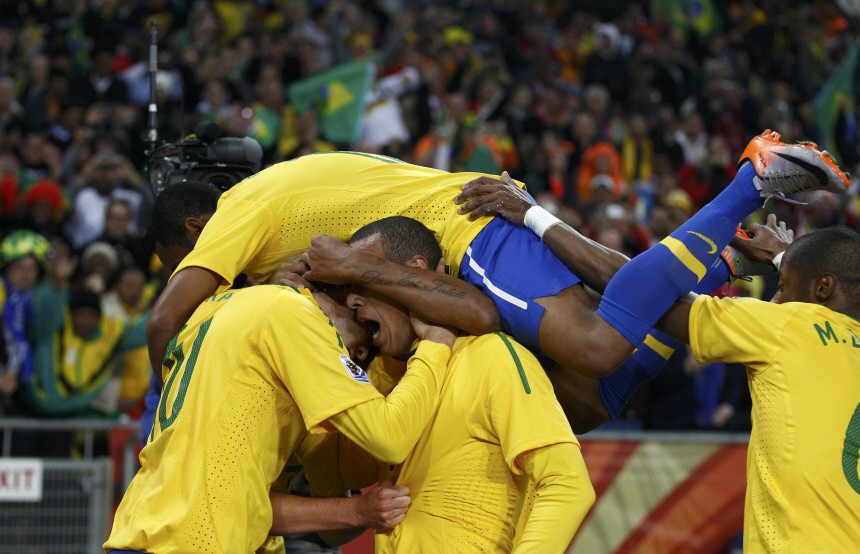 Brazil players celebrate Luis Fabiano's goal during the 2010 World Cup Group G soccer match against Ivory Coast at Soccer City stadium in Johannesburg