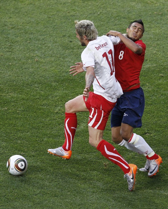 Switzerland's Behrami fouls Chile's Vidal and is subsequently shown a red card during the 2010 World Cup Group H match in Port Elizabeth