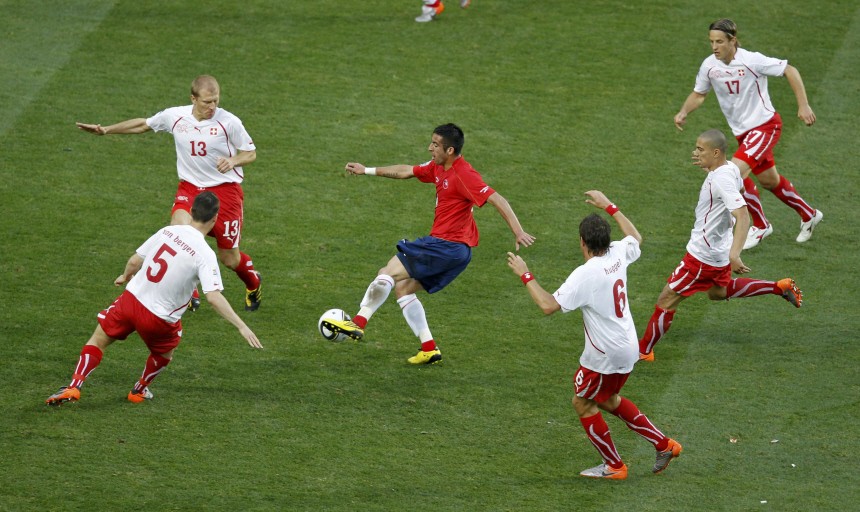 Chile's Isla is surrounded by Swiss players as he tries to pass the ball during a 2010 World Cup Group H match at Nelson Mandela Bay stadium in Port Elizabeth