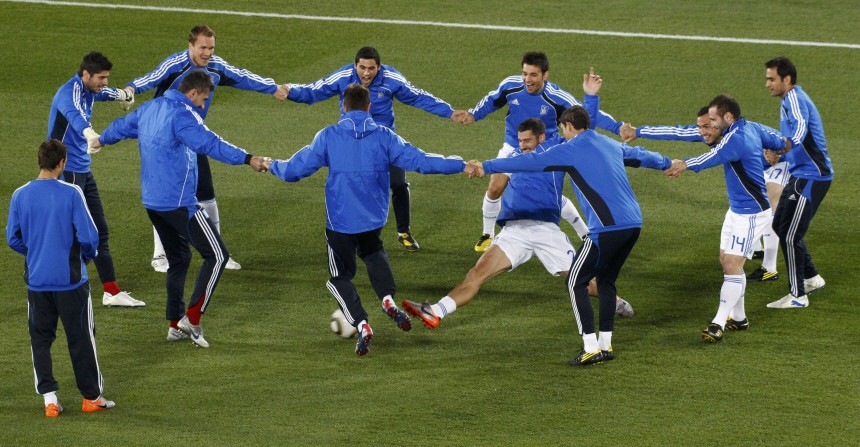 Greece's soccer players warm up ahead of a 2010 World Cup Group B soccer match against Argentina in Polokwane