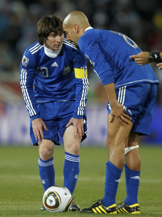 Argentina's Lionel Messi (L) and Juan Veron talk during  a 2010 World Cup Group B soccer match against Greece at Peter Mokaba stadium in Polokwane
