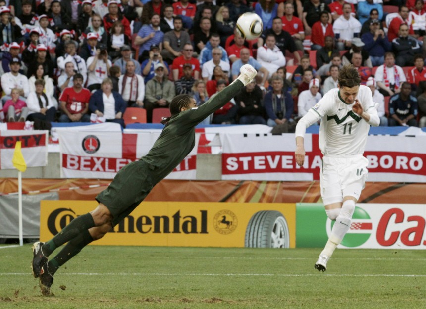 England's goalkeeper David James jumps to punch the ball away from Slovenia's Milivoje Novakovic during their 2010 World Cup Group C soccer match in Port Elizabeth