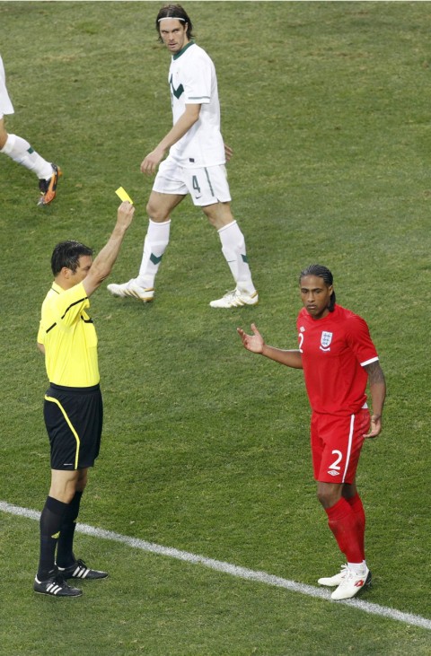Referee Stark shows the yellow card to England's Johnson during the 2010 World Cup Group C soccer match against Slovenia in Port Elizabeth