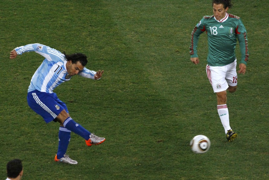 Argentina's Tevez scores a goal past Mexico's Guardado during a 2010 World Cup second round soccer match in Johannesburg