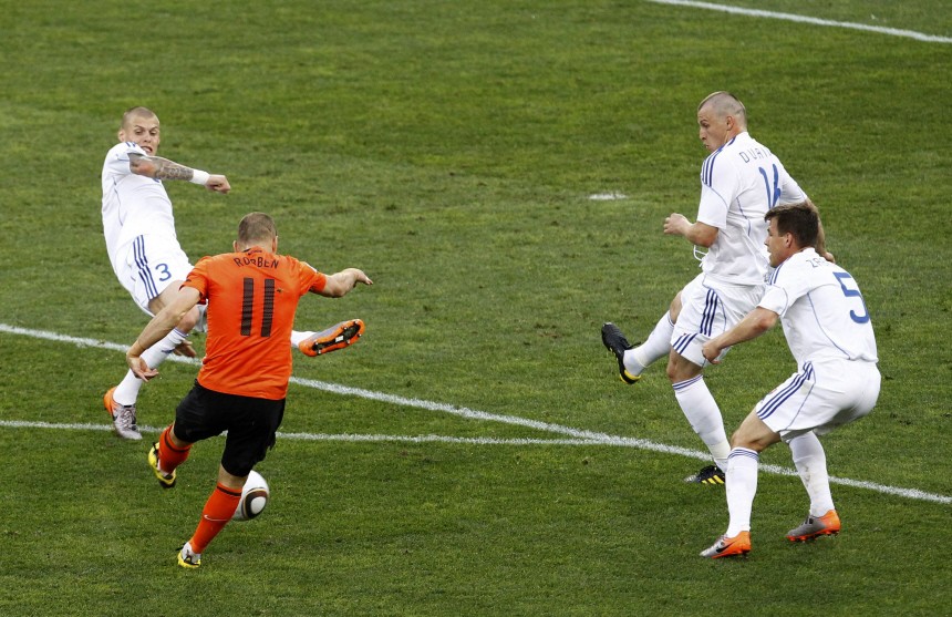 Netherlands' Arjen Robben scores a goal past Slovakia's Martin Skrtel, Jan Durica and Radoslav Zabavnik in Durban