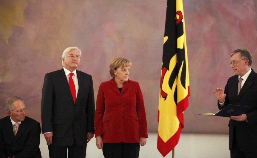 German Chancellor Merkel outgoing Foreign Minister Steinmeier and outgoing Interior Minister Schaeuble listen to German President Koehler during ceremony at Bellevue Castle in Berlin