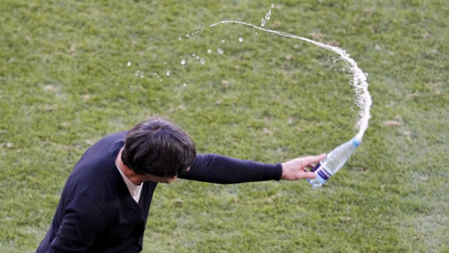 Germany's head coach Loew throws a bottle of water to the ground  during 2010 World Cup Group D soccer match against Serbia  in Port Elizabeth