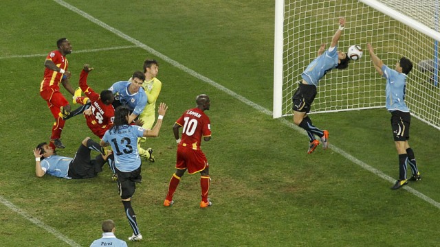Uruguay's Luis Suarez saves the ball with his hands during a 2010 World Cup quarter-final soccer match at Soccer City stadium