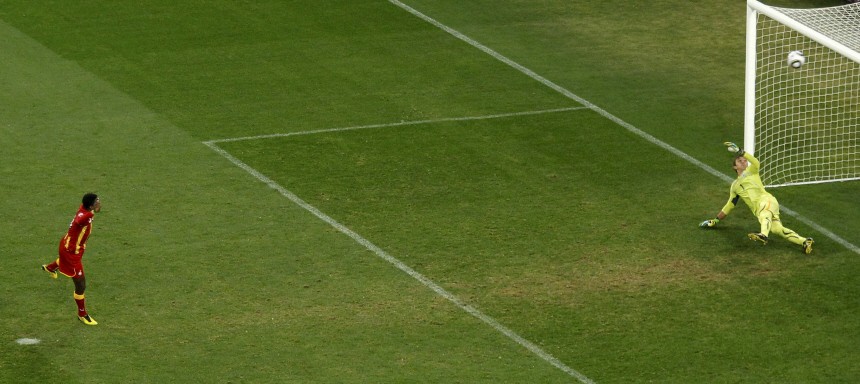 Ghana's Gyan reacts after his penalty shot hits the cross bar during extra time at a 2010 World Cup quarter-final soccer match in Johannesburg