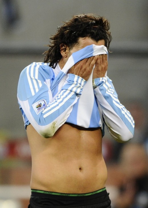 Argentina's Carlos Tevez wipes his face during the 2010 World Cup quarter-final soccer match against Germany at Green Point stadium in Cape Town